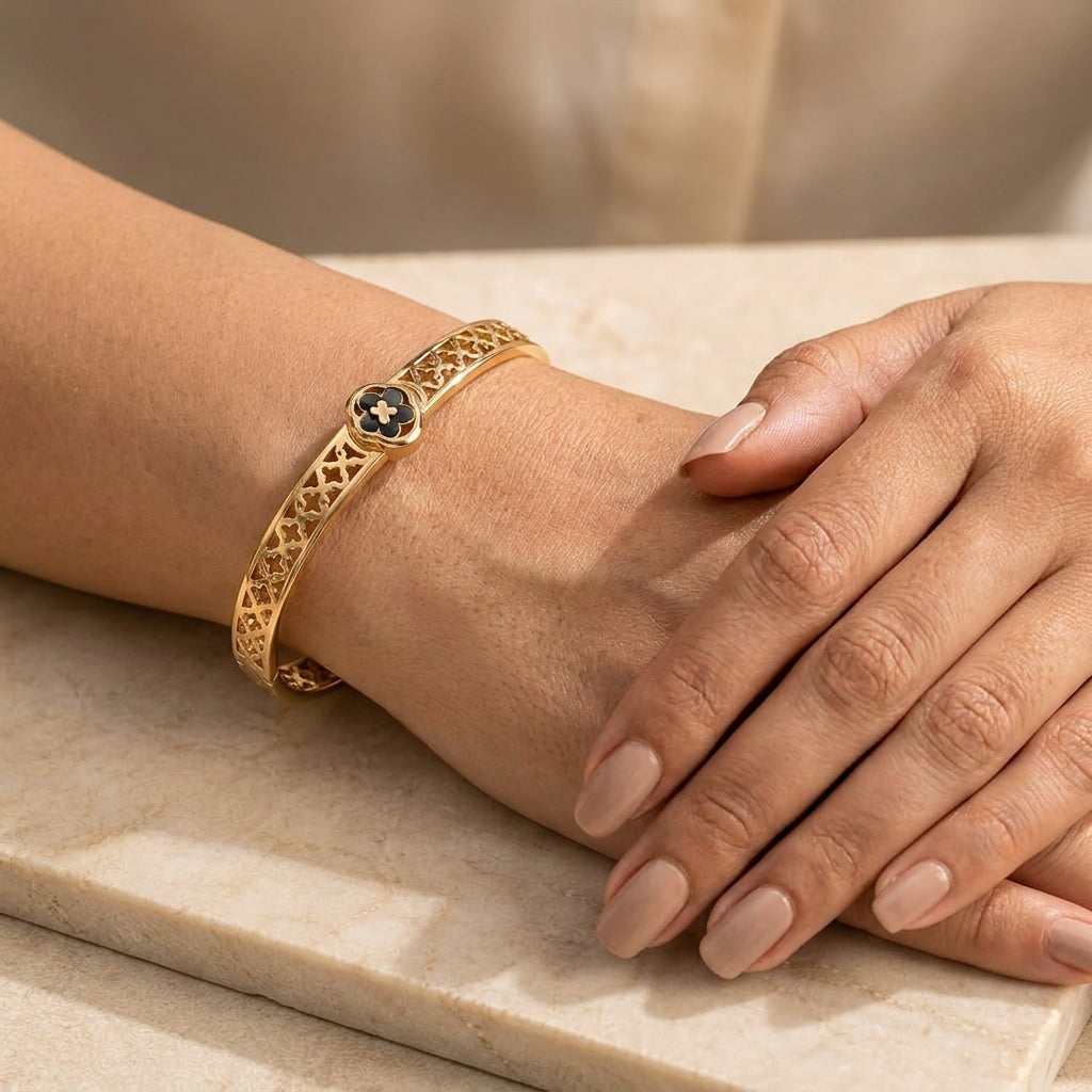 Elegant Gold-Tone Stainless Steel Bangle Bracelet with Black Clover Charm